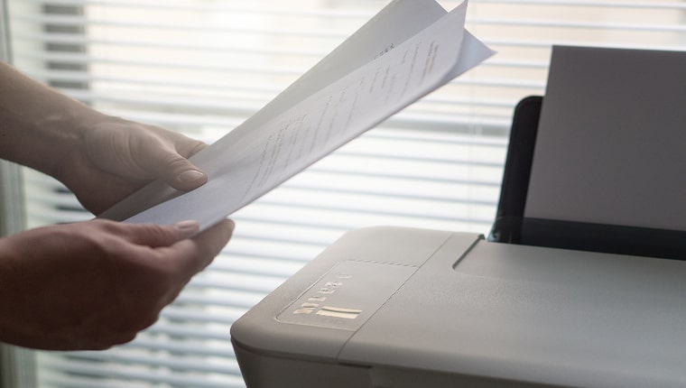 printer with printed sheets of paper